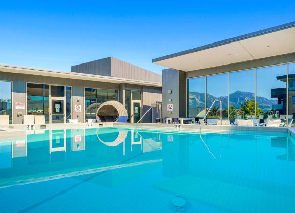 a swimming pool with a building in the background