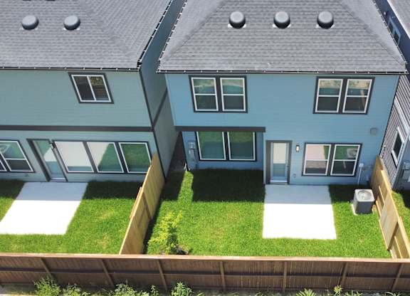 a view of the backyard of a house from above