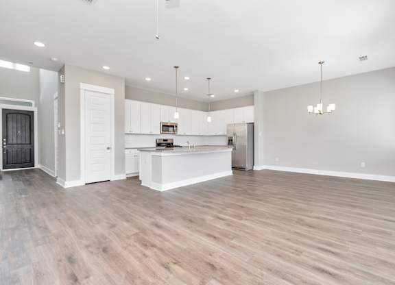 the living room and kitchen in a 555 waverly unit
