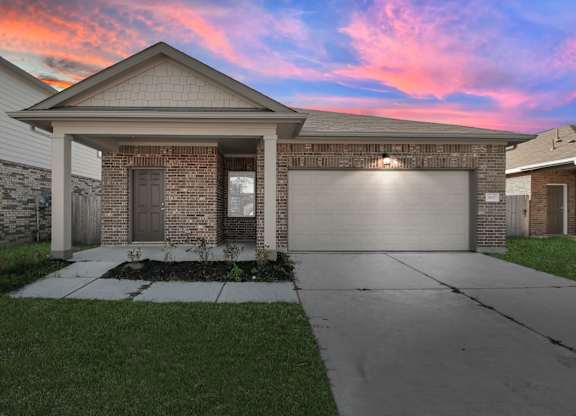 A house with a garage and a driveway.