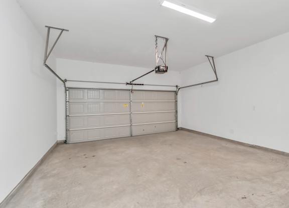 the inside of a garage with a white wall and a white garage door