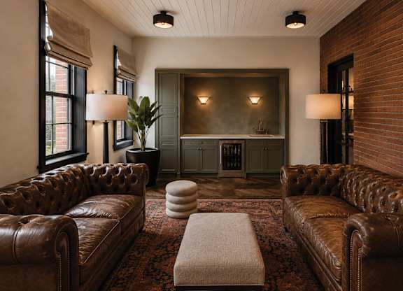 A living room with brown leather couches and a fireplace.