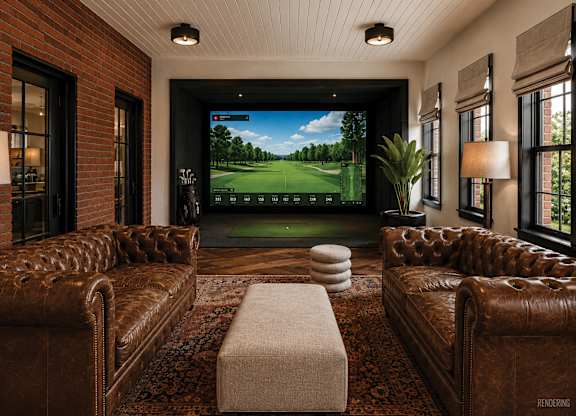 A living room with a large screen tv and a couch.