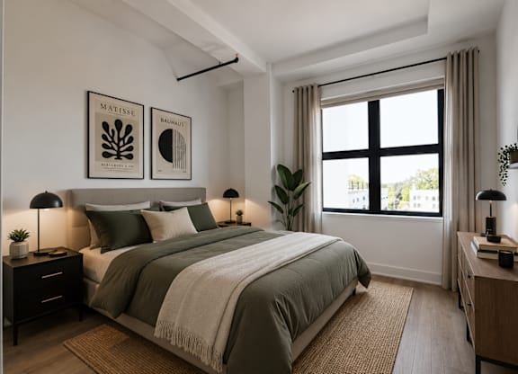 A bedroom with a bed, nightstands, and a window.