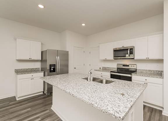 A kitchen with granite countertops and stainless steel appliances.
