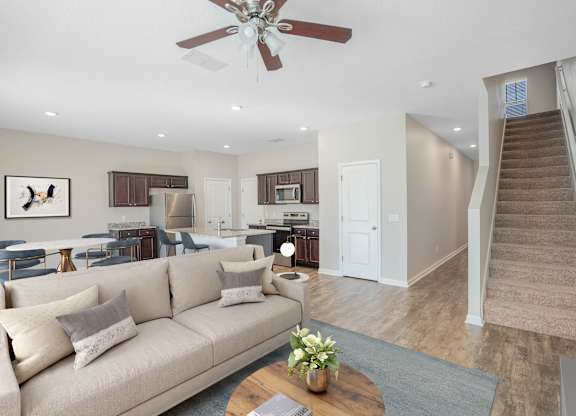 A living room with a beige couch and a coffee table.
