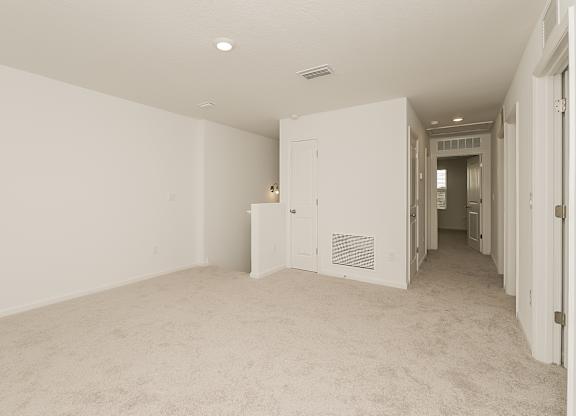 A room with white walls and carpeted floor.