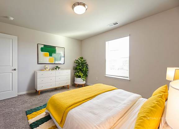 A bedroom with a bed, dresser, and a painting on the wall.