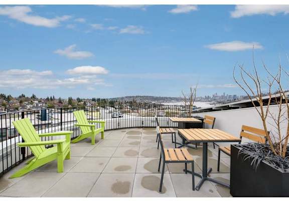 Apartments for Rent in Fremont - Inspire Fremont - Rooftop Lounge with Tables and Chairs, and a Beautiful View of the City