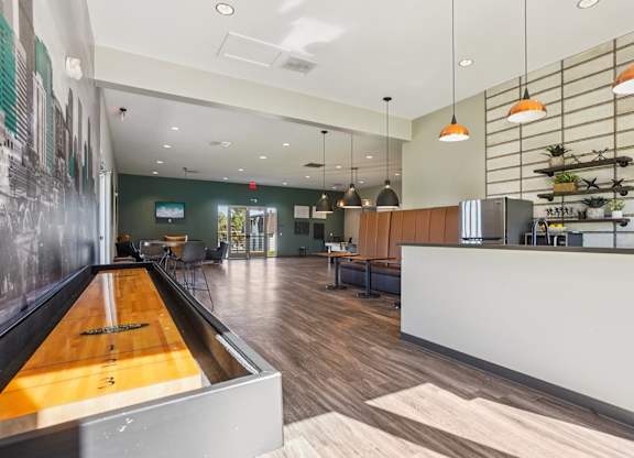 Community clubhouse at Willowstone Apartments in Southeast Denver with seating areas, wood-style flooring, and updated gathering spaces for residents