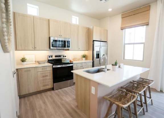 A kitchen with wooden cabinets and a white countertop.