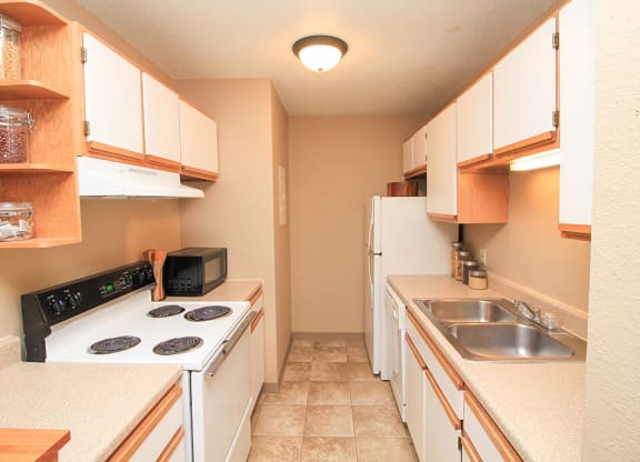 a kitchen with a stove top oven next to a sink