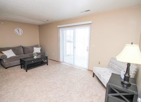 a living room with a sliding glass door