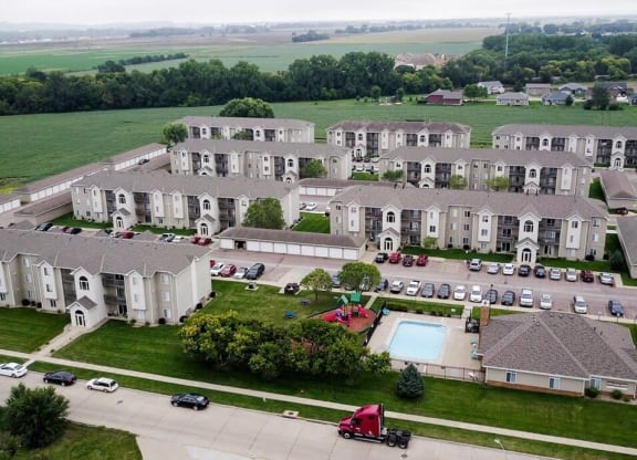 an aerial view of an apartment complex with a pool