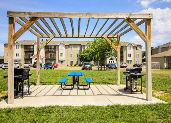 our apartments showcase a clubhouse with a picnic table and grill