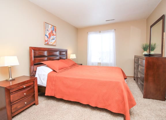 a bedroom with a bed and a dresser