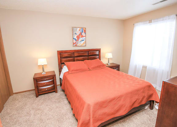 a bedroom with a bed and two night stands