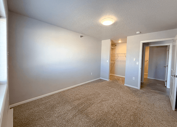 A room with carpeted floor and white walls.