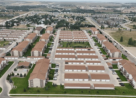 A large housing complex with multiple buildings and parking lots.