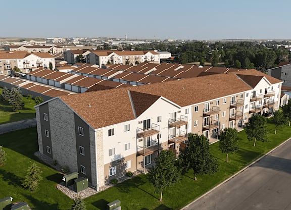Apartment complex with a mix of beige and brown roofs.