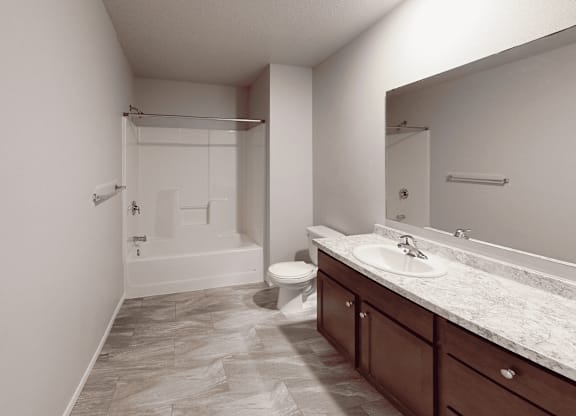A bathroom with a toilet, sink, and bathtub.