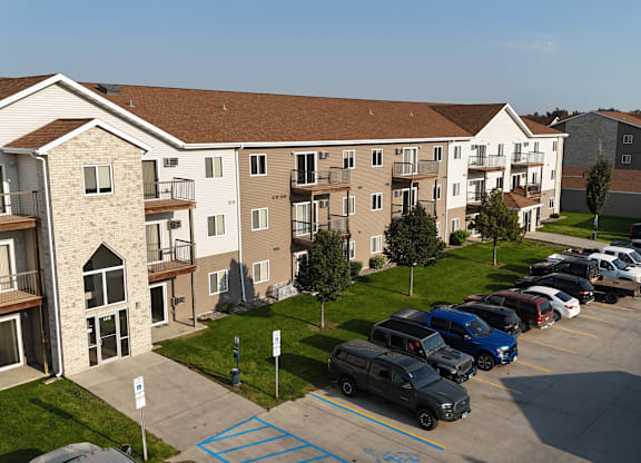 A parking lot in front of apartment buildings.