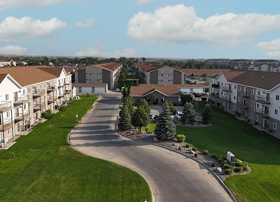 A road in a residential area with houses on both sides.