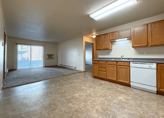 A kitchen with wooden cabinets and a dishwasher.