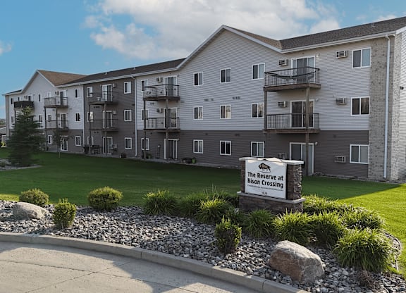 A large apartment complex with a sign that says