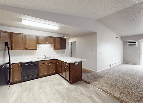 A kitchen with wooden cabinets and a black oven.