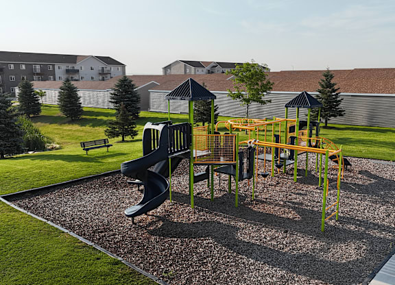 A playground with a yellow and black slide.