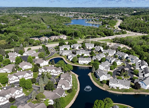 A bird's eye view of a residential area with houses and a river.