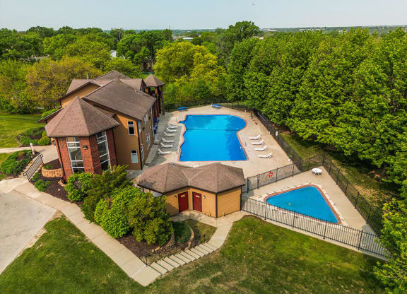 arial view of a house with a large pool in the backyard