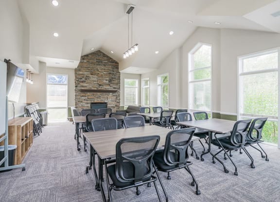 clubhouse with tables and chairs and a fireplace
