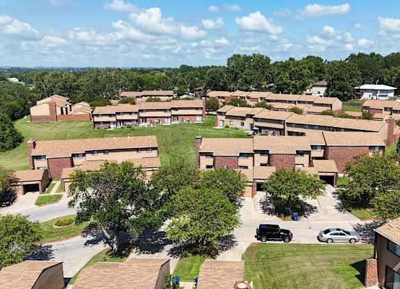 A large building complex with a parking lot in front.