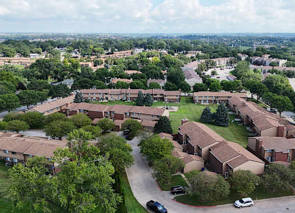 A bird's eye view of a residential area with houses and cars.