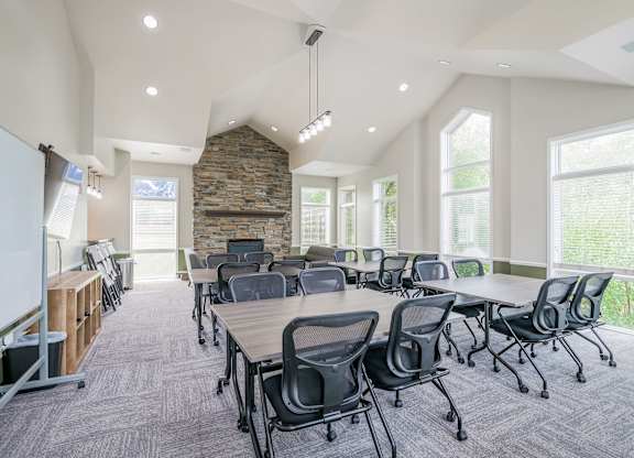 A conference room with a stone wall and a whiteboard.