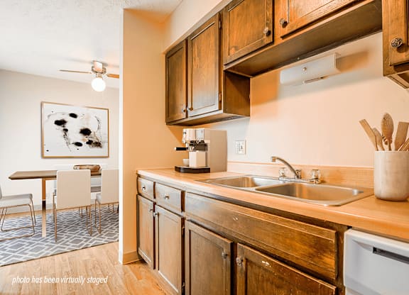 Apartment kitchen with dishwasher and wooden cabinets