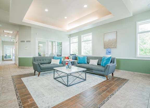 A living room with a grey couch and a coffee table.