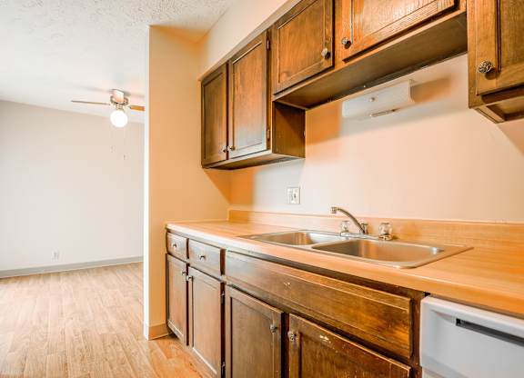 A kitchen with wooden cabinets and a white refrigerator.