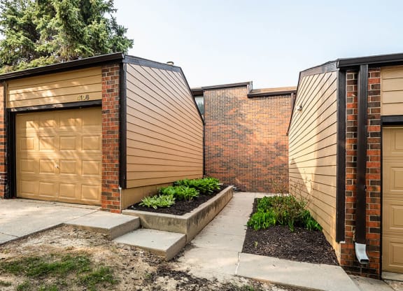 a row of garages with brown doors