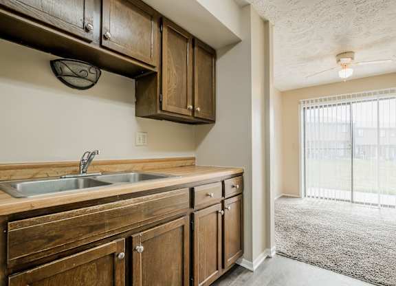 A kitchen with wooden cabinets and a sink.