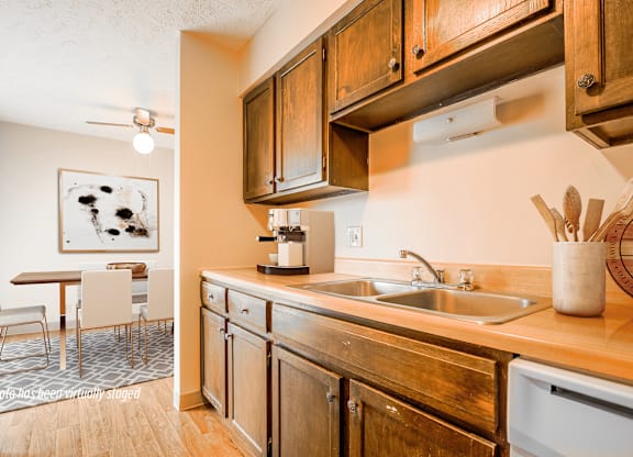 A kitchen with wooden cabinets and a fridge.