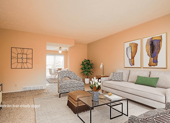 A living room with a couch, chair, and coffee table.