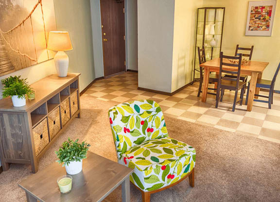 a living room with a dining room in the background