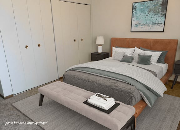 A bedroom with a large bed and a painting on the wall.