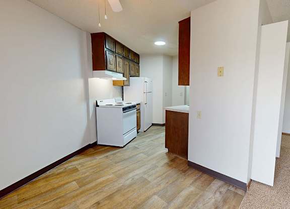 A kitchen with a white dishwasher and a white refrigerator.