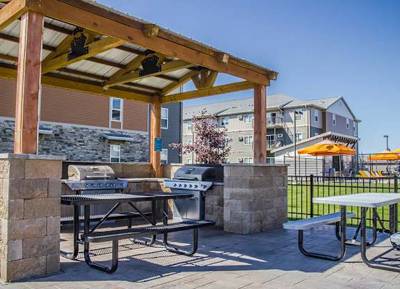 a patio with a grill and picnic table at the villas at falling waters in west om