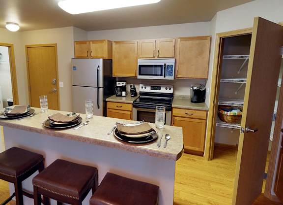 a kitchen with a center island and a stove top oven