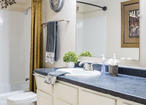 apartment bathroom with a toilet, sink, and bathtub